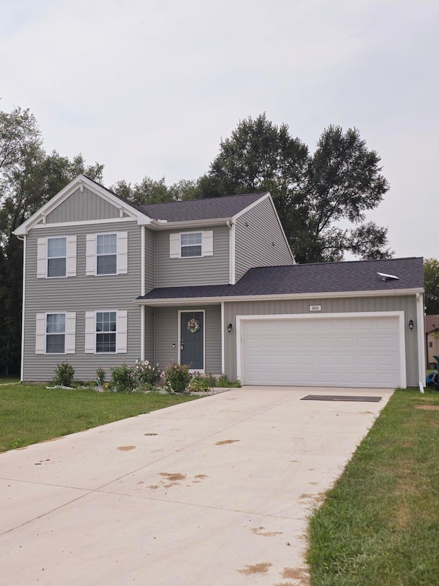 view of front of property featuring a garage and a front lawn