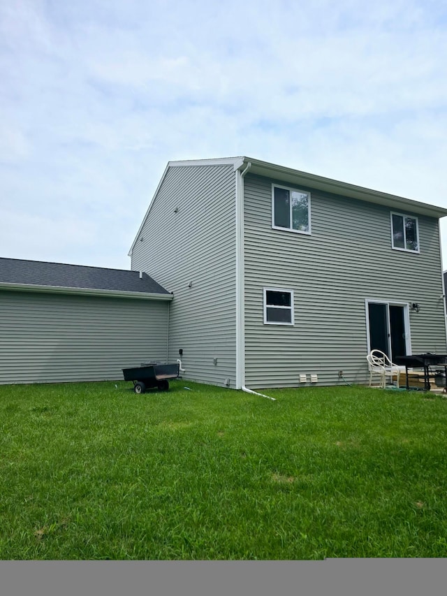 rear view of house with a yard