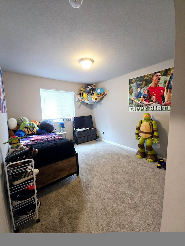 bedroom with carpet and a textured ceiling