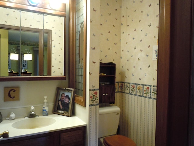 bathroom with toilet and vanity