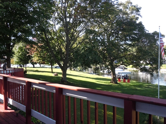 exterior space featuring a lawn and a water view