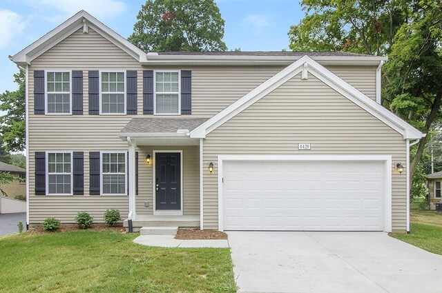 view of front facade featuring a garage and a front lawn