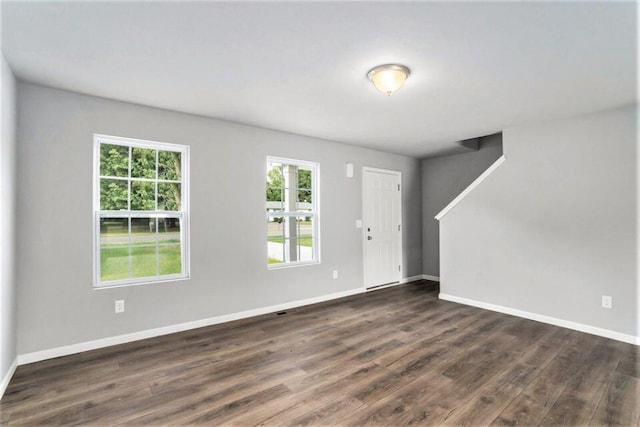 spare room featuring wood-type flooring