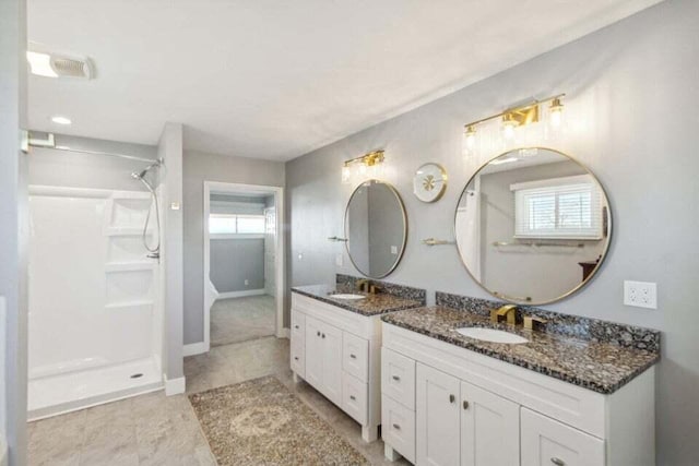 bathroom with vanity and a shower