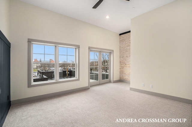 carpeted spare room featuring ceiling fan