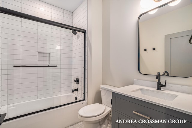 full bathroom featuring vanity, bath / shower combo with glass door, and toilet