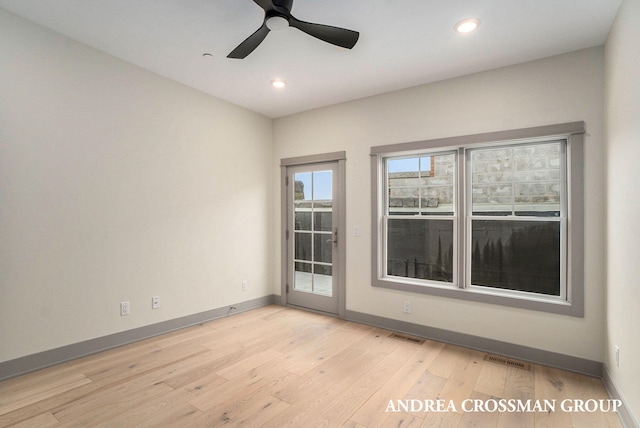 empty room featuring light wood-type flooring and ceiling fan