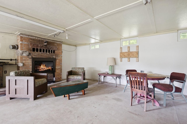 living room with concrete floors and a fireplace