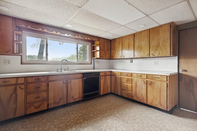 kitchen with black dishwasher, a paneled ceiling, and sink