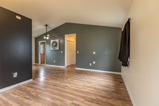 spare room with lofted ceiling, hardwood / wood-style floors, and ceiling fan