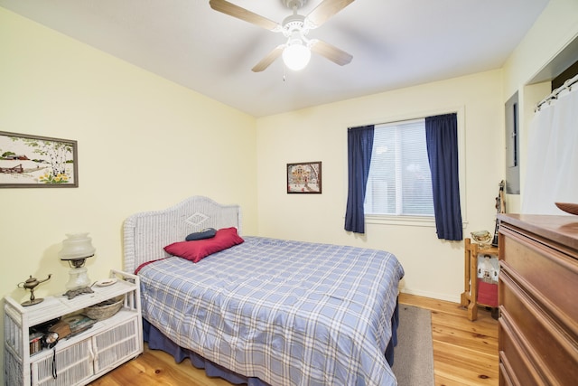 bedroom with ceiling fan and wood-type flooring