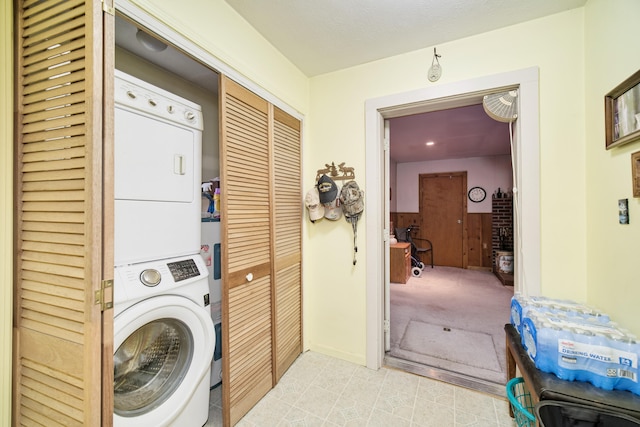 clothes washing area with stacked washer / drying machine