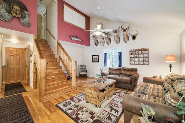 living room featuring high vaulted ceiling, light wood-type flooring, and ceiling fan