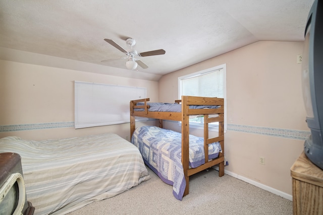 bedroom with ceiling fan, carpet, and lofted ceiling