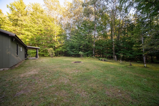 view of yard with an outdoor fire pit