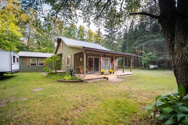 back of house with a porch and a lawn