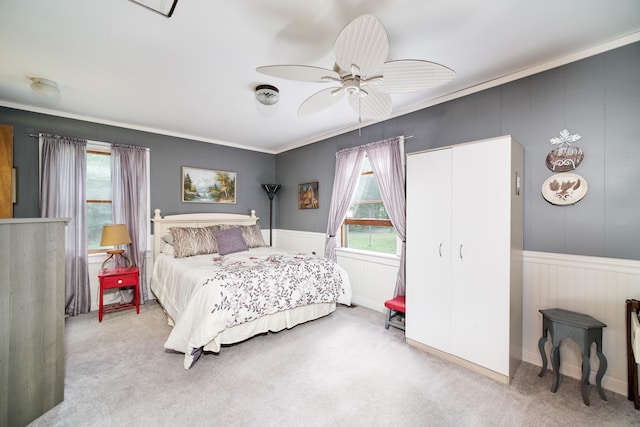 bedroom featuring ceiling fan, light colored carpet, and ornamental molding