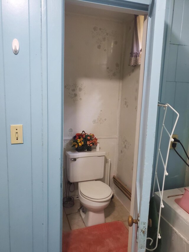 bathroom featuring tile patterned flooring and toilet