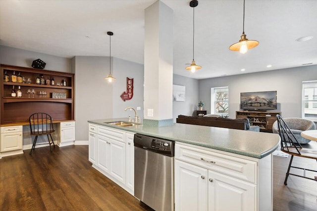 kitchen with a sink, dark wood-style floors, open floor plan, built in desk, and dishwasher