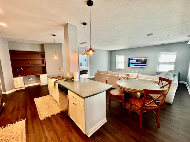 kitchen with a textured ceiling, dishwasher, dark hardwood / wood-style floors, and decorative light fixtures