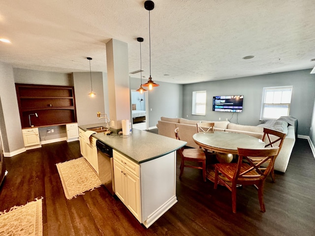 kitchen with dishwashing machine, a textured ceiling, dark wood-type flooring, and open floor plan