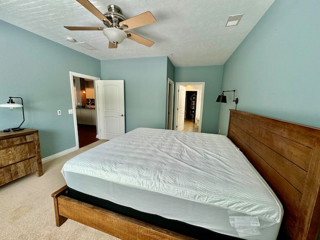 carpeted bedroom featuring a textured ceiling and ceiling fan