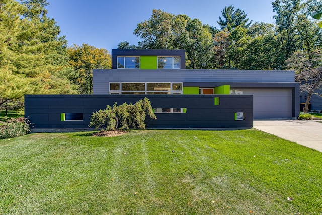 modern home featuring a garage and a front lawn