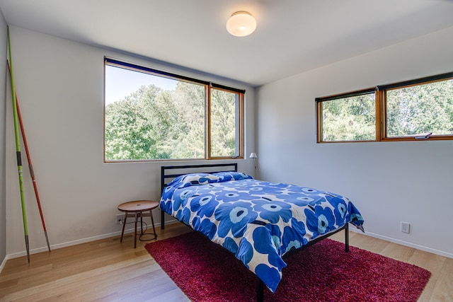 bedroom with light hardwood / wood-style flooring