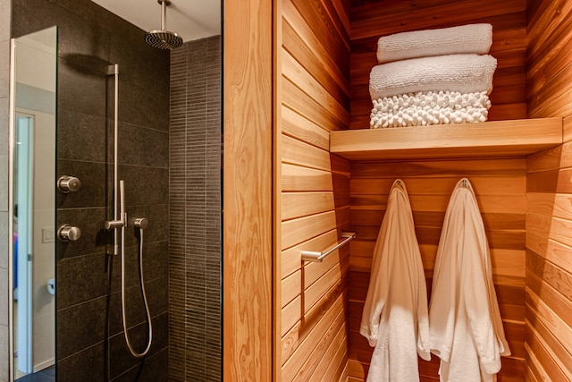 mudroom featuring wooden walls