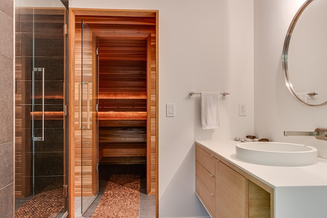 bathroom with tile patterned flooring, vanity, and an enclosed shower