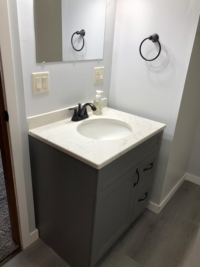 bathroom featuring hardwood / wood-style flooring and vanity