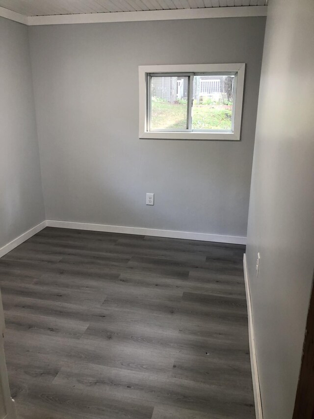 empty room with wood ceiling and dark hardwood / wood-style floors