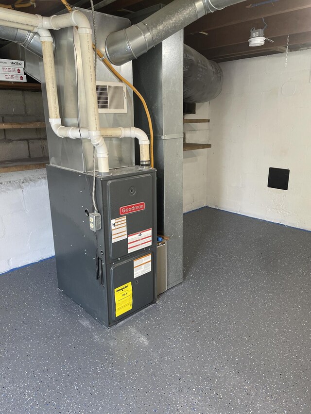 utility room featuring heating unit