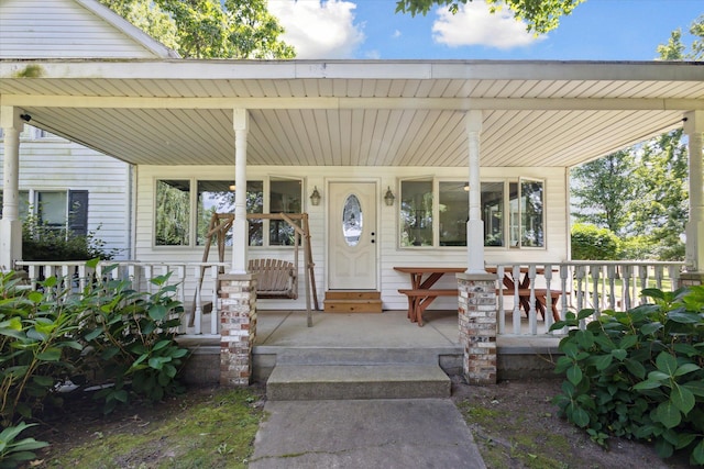 doorway to property featuring a porch