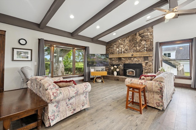 living room featuring a fireplace, lofted ceiling with beams, wood-type flooring, and ceiling fan