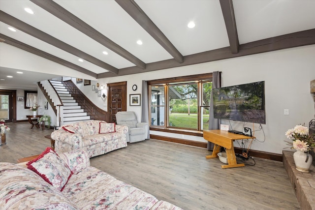 living room with hardwood / wood-style flooring and vaulted ceiling with beams