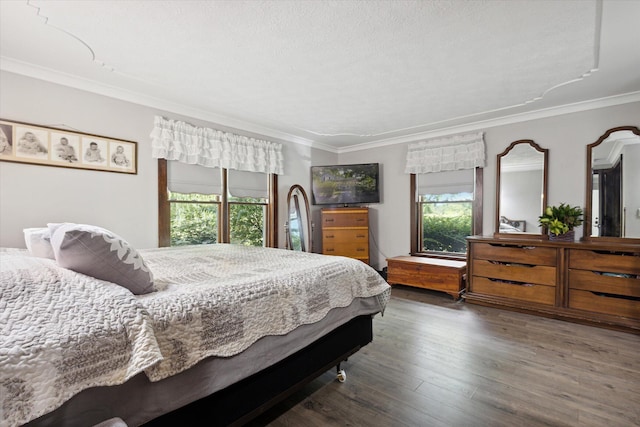 bedroom with hardwood / wood-style floors, a textured ceiling, and ornamental molding