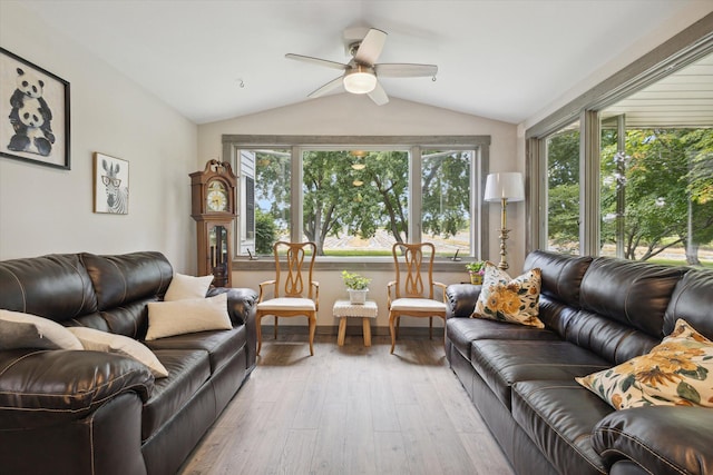 living room featuring light hardwood / wood-style flooring, ceiling fan, plenty of natural light, and vaulted ceiling