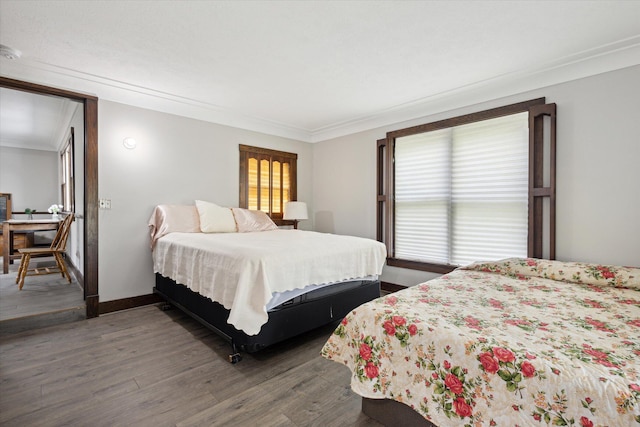 bedroom with ornamental molding and hardwood / wood-style flooring