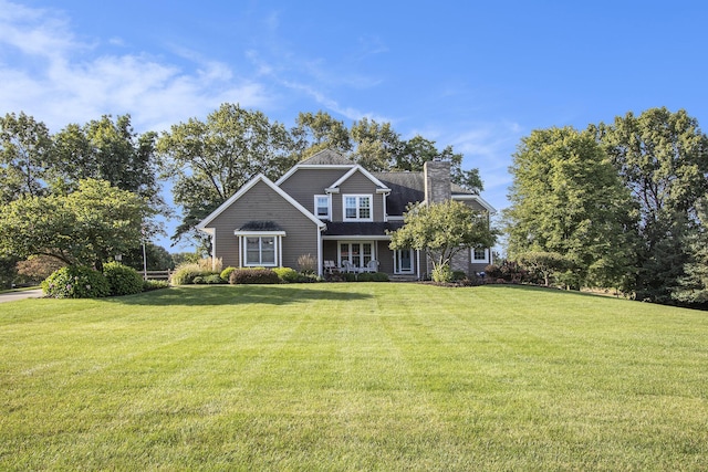 view of front of house featuring a front yard and a chimney