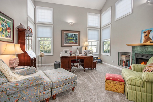 interior space featuring high vaulted ceiling, a wealth of natural light, and a tiled fireplace