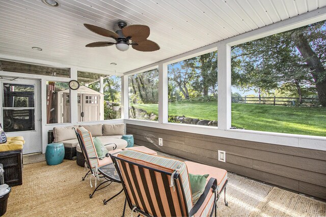 sunroom / solarium featuring wooden ceiling and ceiling fan