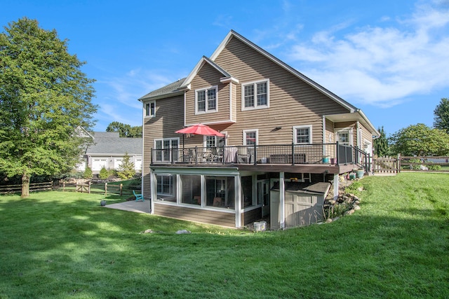 rear view of house featuring a lawn and a wooden deck