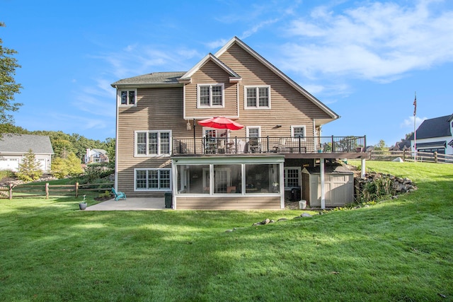 back of house with a patio, a yard, a wooden deck, and a shed