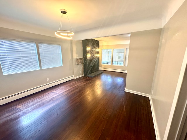 empty room featuring a baseboard radiator and dark hardwood / wood-style flooring