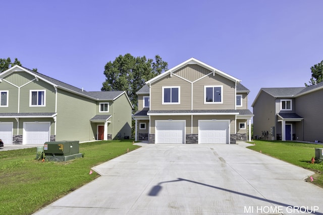 view of front property featuring a garage, a front lawn, and central AC