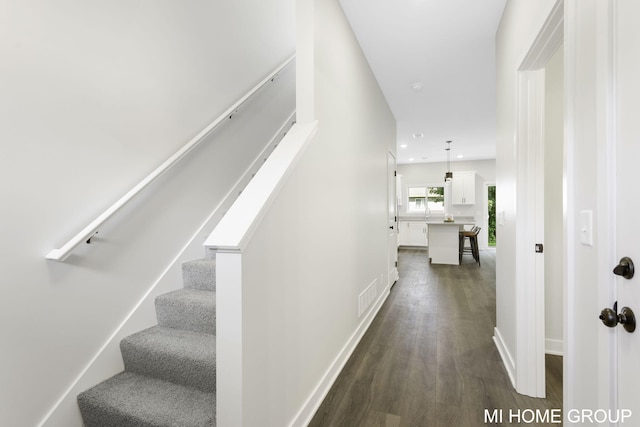 stairway with recessed lighting, wood finished floors, visible vents, and baseboards