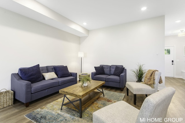 living room with recessed lighting and wood finished floors