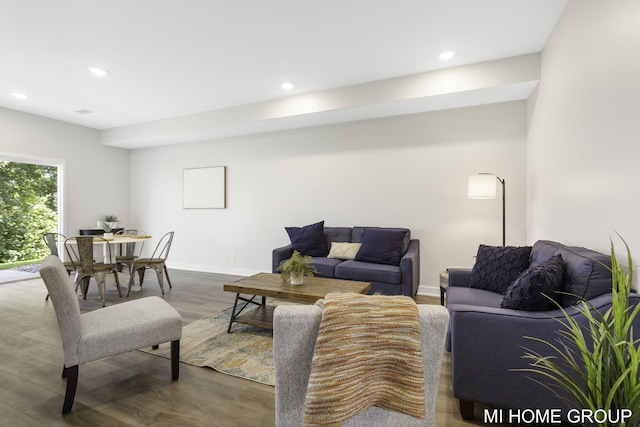 living area with recessed lighting, baseboards, and wood finished floors