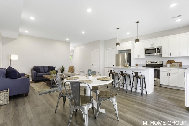 dining room featuring recessed lighting, wood finished floors, and visible vents